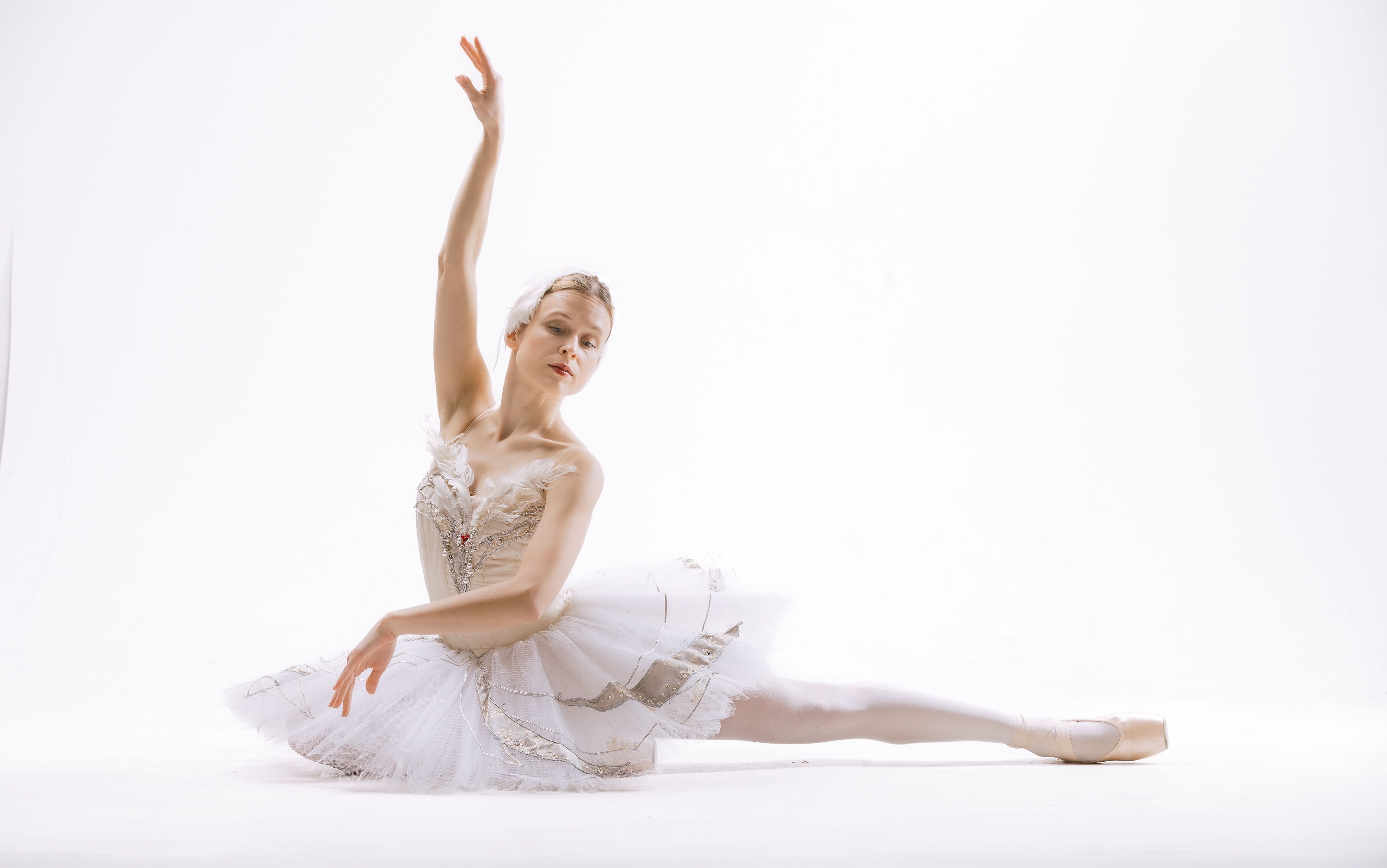 Elegant ballet dancer in swan pose